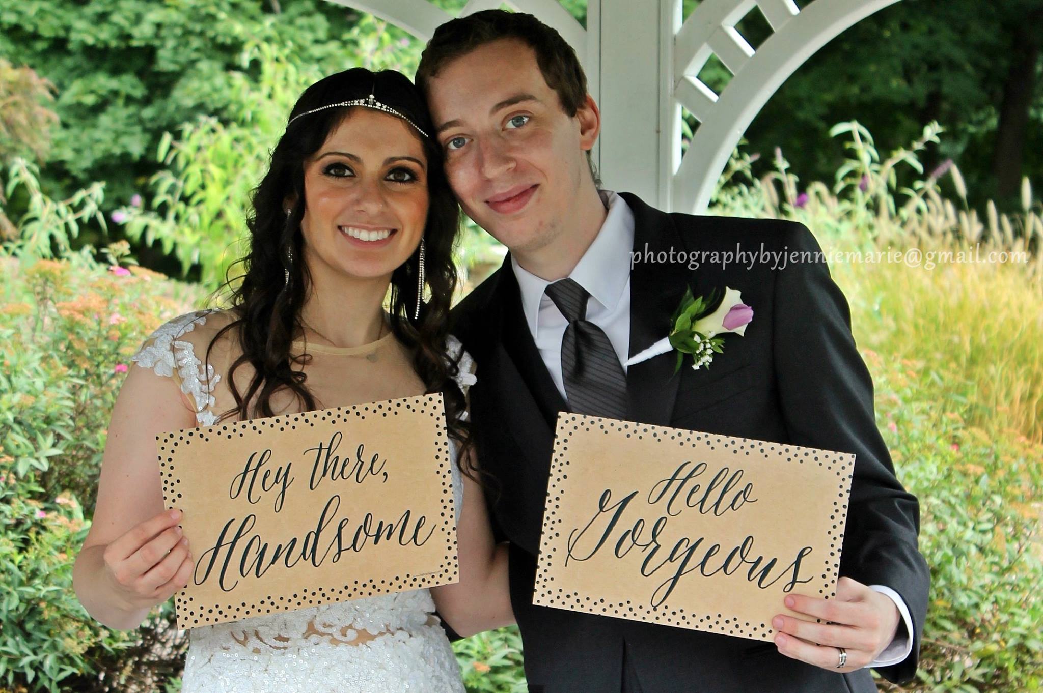 couple in gazebo holding signs hey there handsome and hello georgeous