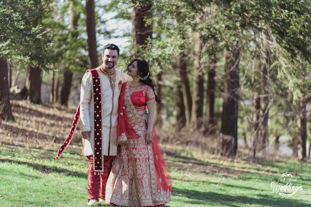 indian-wedding-couple-walking-on-grounds-smiling-at-camera-at-danbury-wedding