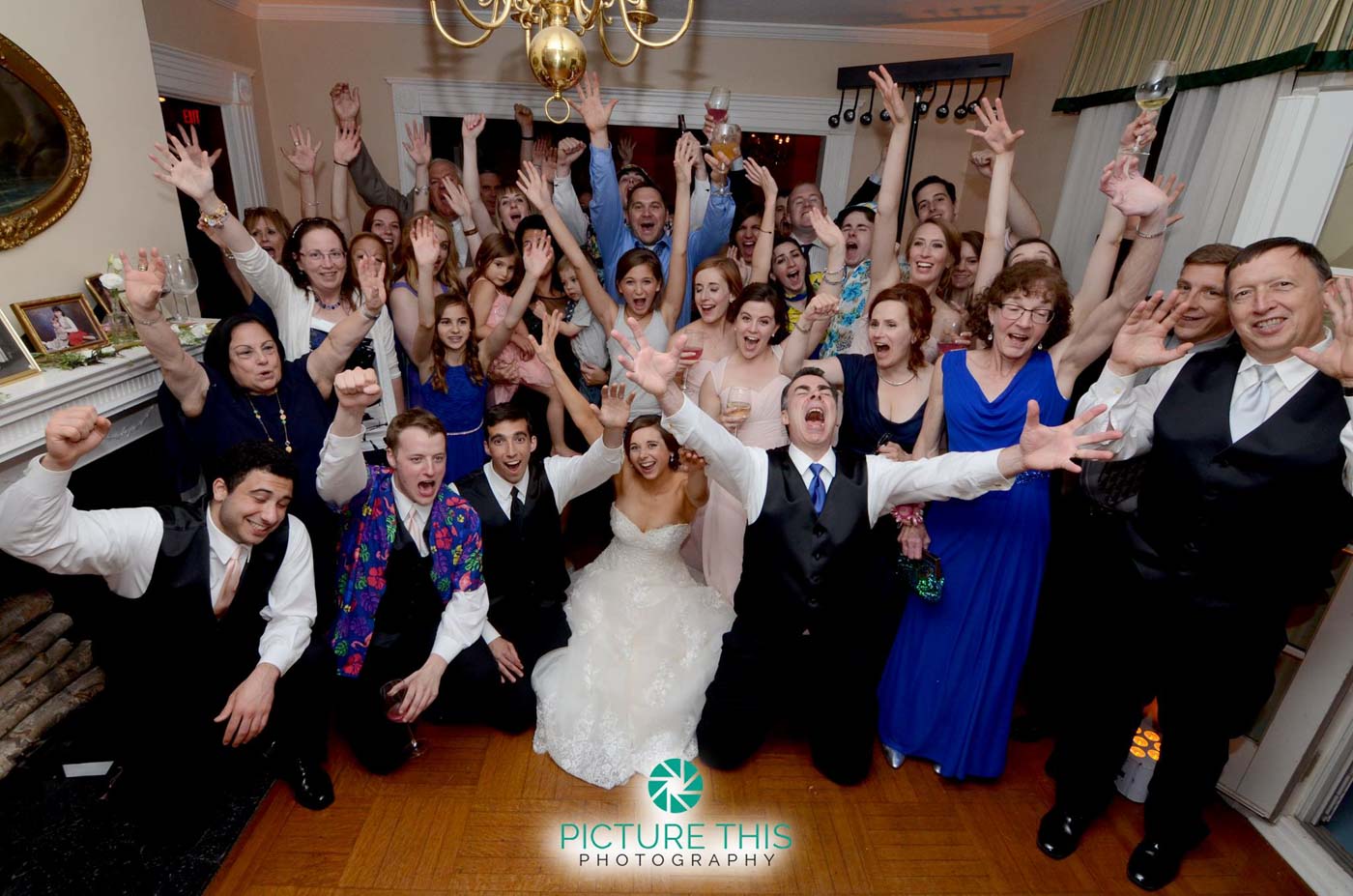 wedding-guests-bridal-party-grouped-together-smiling-at-the-camera