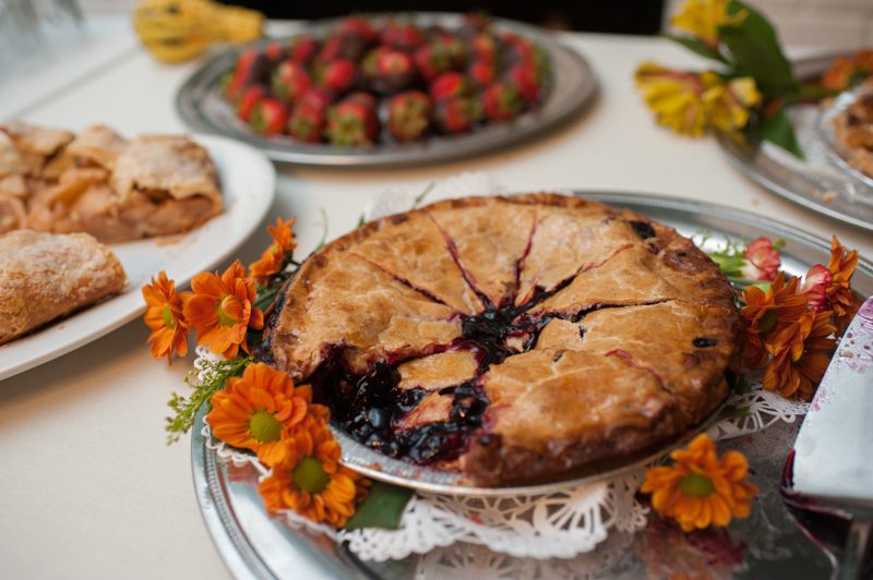 blueberry pie and chocolate covered strawberries on the table