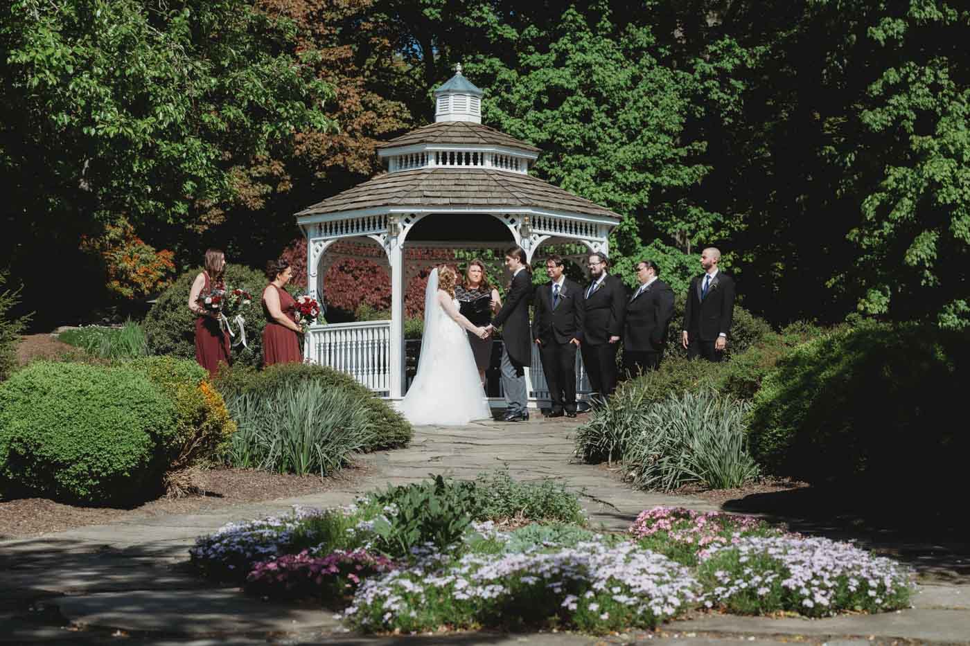 gazebo-wedding-couple-exchanging-vows-before-guests