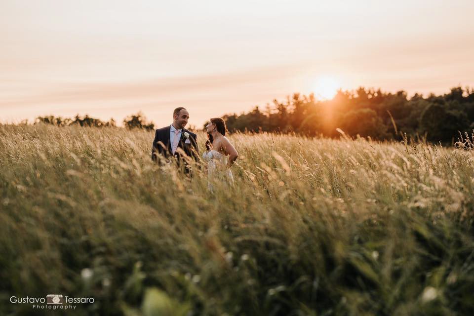 tarrywile-hikers-in-hayfield-at-sunset