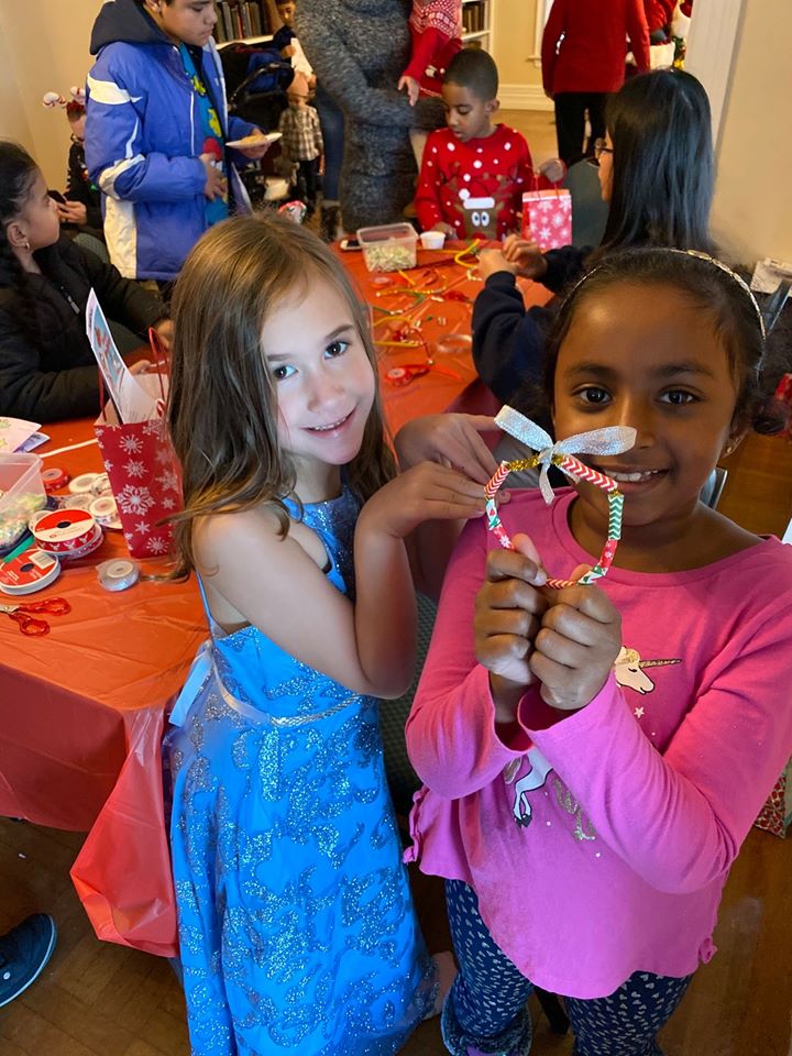 candy-cane-wreath-craft-held-by-two-young-girls