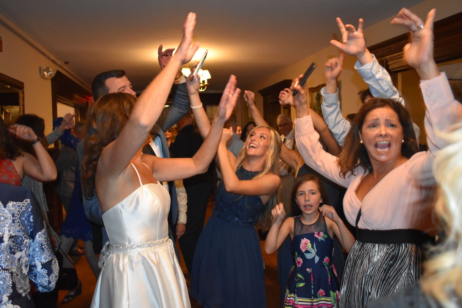 wedding-reception-dancing-guests-with-arms-raised