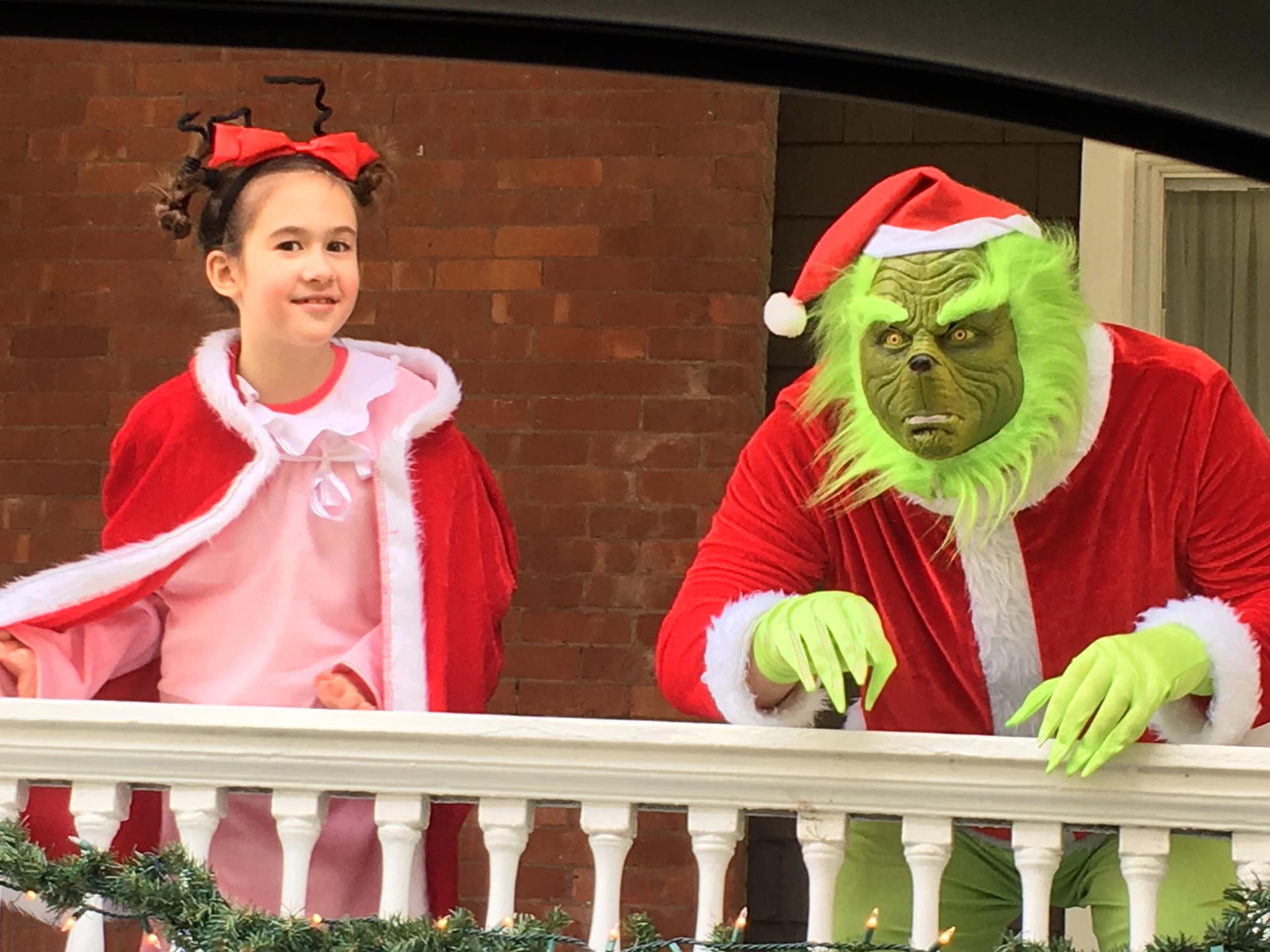 the grinch and cindy lou who greet you from the veranda